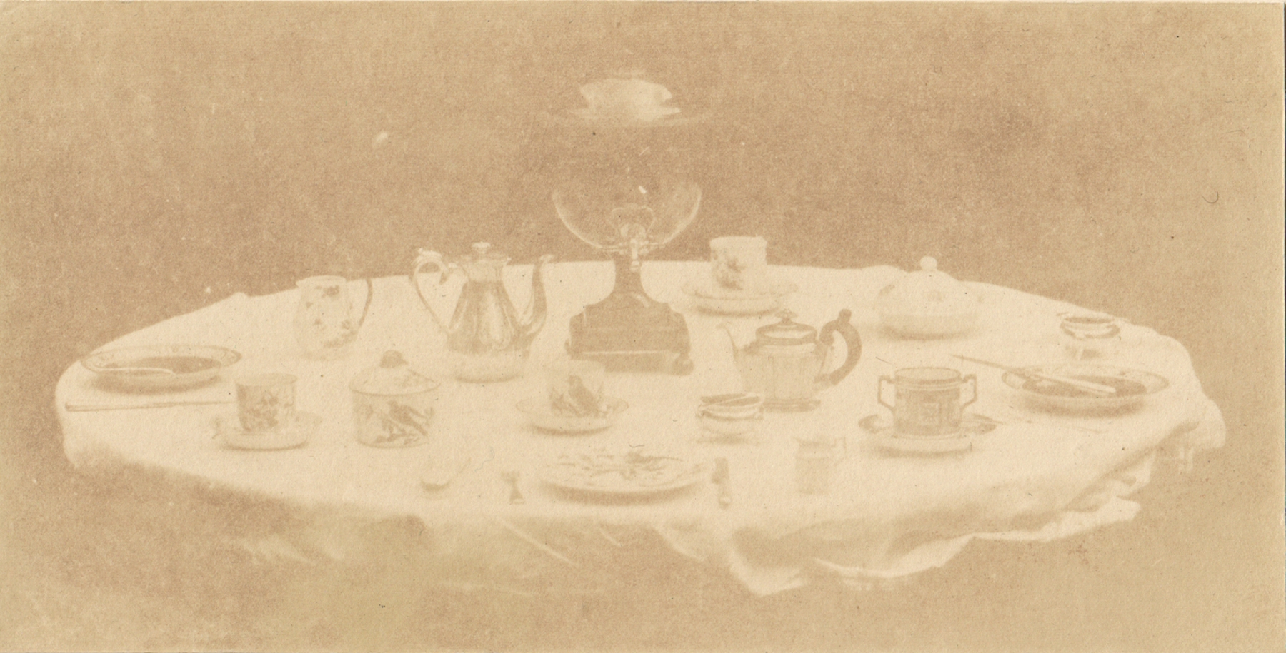 William Henry Fox TALBOT (English, 1800-1877) Table set for tea, 1841-1842 Varnished salt print from a calotype negative 8.5 x 16.8 cm mounted on card, ruled  "Patent Talbotype Photogenic Drawing" label on mount verso
