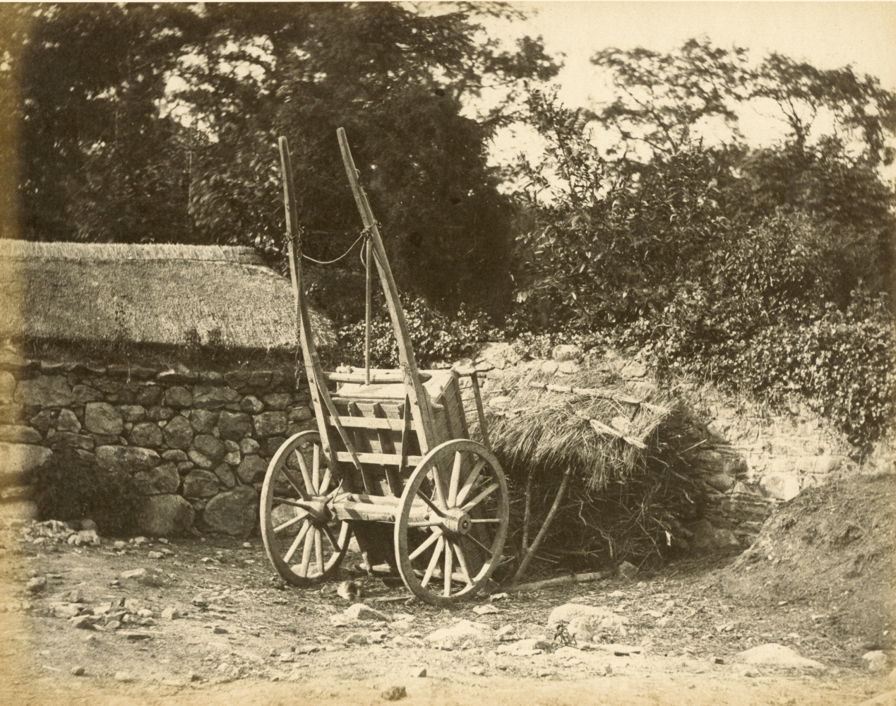 Hugh OWEN (English, 1808-1897) Cart and thatched kindling storehouse Albumen print, 1860s-1870s, from a paper negative, before 1855 17.6 x 22.5 cm mounted on 26.0 x 28.3 cm album sheet Numbered "36" in pencil on mount