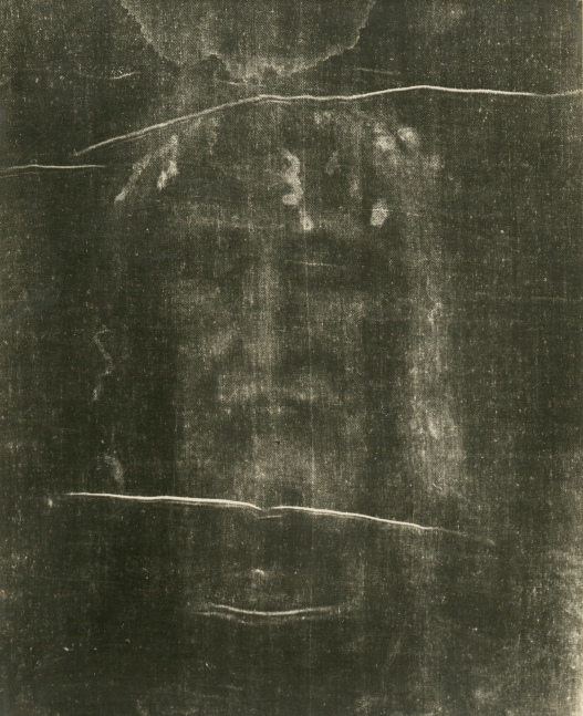 Giuseppe ENRIE (Italian, 1886-1961) Detail of the Shroud of Turin, 1931 Gelatin silver print from a glass negative 29.5 x 23.4 cm mounted on 41.9 x 31.5 cm paper, ruled Blindstamped “FOT. CAV. G. ENRIE / RIPRODUZIONE INTERDETTA”. Printed “SANTO VOLTO DEL DIVIN REDENTORE / (PARTICOLARE DELLA S. SINDONE) / CAV. G. ENRIE FOTOGRAFÒ / RIPRODUZIONE INTERDETTA / ADORAMUS TE, CHRISTE, ET BENEDICIMUS TIBI / IL PRESIDENTE DELLA COMMISSIONE ESECUTIVA / TORINO 3 – 24 MAGGIO 1931” on mount with ecclesiastical authentication in facsimile signatures. Luigi Gay Caroleria label on mount verso.